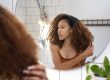 Vrouw met veel krullen bekijkt haar haartextuur